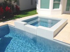 an outdoor swimming pool with blue water