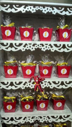 a shelf filled with red buckets and candy