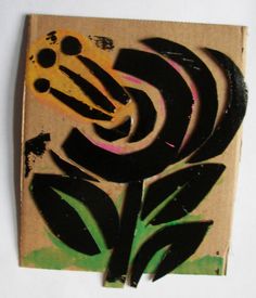 a piece of cardboard with black and yellow flowers on it