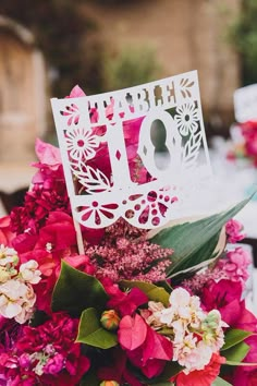 a bouquet of flowers with a happy 10th sign on it's centerpiece in front of a table