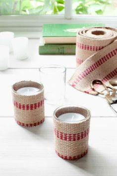 three rolls of burlap tape sitting on top of a table next to glasses