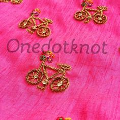 pink and gold embroidered fabric with golden brooches