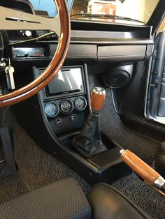 the interior of a car with steering wheel and dashboard