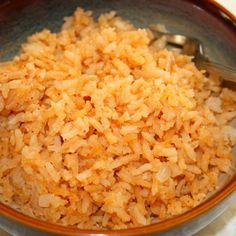 a bowl filled with rice on top of a table