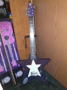 an electric guitar with a purple star on it