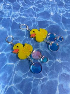 "These duckie earrings are light weight and fun for every day! Makes a great gift for those duck lovers in your life. Graphically designed and then cut using a laser in acrylic. Earrings are then finished with silver colored iron and brass chain and hooks. Measure about 4\" long from top of hook to bottom of earring Have any questions? Please feel free to contact me! No refunds or returns, but please tell me if something goes wrong with your order. For international buyers from Europe, Australia Crazy Earrings, Craft Clay, Weird Jewelry, Quirky Earrings, Laser Cut Earrings, Funky Earrings, Funky Jewelry, Air Bubbles, Acrylic Earrings