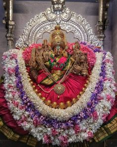 the statue is surrounded by flowers and other decorations