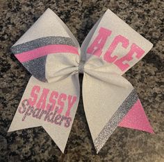 Custom cheer bow done in full glitter. Bow is done in your custom colors and any text upper.  Lower right tail can have any text/number Bow is fully customizable and can be changed if needed. Bow comes standard on hair tie. measures approx 7x7 Cute Cheer Bows Pink, Pink Out Cheer Bows, October Pink Cheer Bows, Pink Cheer Bows, October Cheer Bows, Cute Cheer Bows, Dance Bows, Varsity Cheer, Custom Cheer Bows