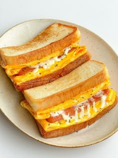 three slices of toasted cheese and bacon sandwich on a plate