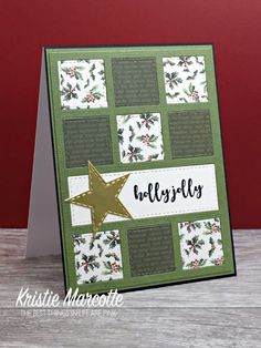 a close up of a christmas card with a star on the front and holly - themed background