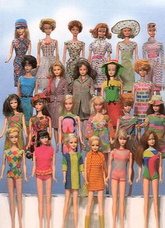 a group of barbie dolls standing next to each other