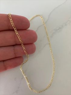 "Solid 14K Yellow Gold Figaro Chain Necklace, Hollow, 1.9mm Wide, Real Gold Chain, Figaro Link Chain, Figaro Curb Chain, Stacking, Layering This beautiful Solid 14k Yellow Gold necklace can be worn as a choker, as a layering piece or stacking piece. It will add statement to your outfit. It can be combined with multiple chains of different lengths to give the messy chains look. It comes available in 14k Yellow Gold. This is real gold. ♦ Materials: 14k Gold ♦ Available colors: Gold ♦ Necklace meas Gold Figaro Chain, Necklace Measurements, Real Gold Chains, Gold Circle Necklace, Figaro Chain Necklace, 14k Yellow Gold Necklace, Mens Gold Jewelry, Long Silver Necklace, Gold Cross Pendant