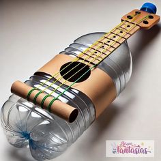 a wooden ukulele made out of an empty plastic bottle with a string attached to it