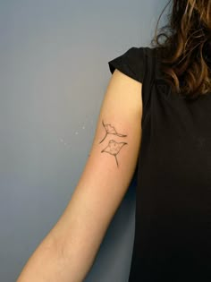 a woman with a small tattoo on her arm