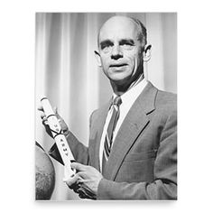 a man in a suit holding a toothbrush next to a ball and an apple