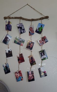 a bunch of pictures hanging on a wall with some clothes pins attached to the pegs