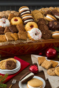 an assortment of cookies and pastries in a basket on a table with christmas decorations