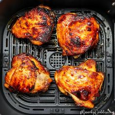 four pieces of chicken cooking in an air fryer