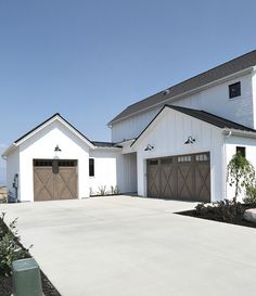 a large white house with two garages