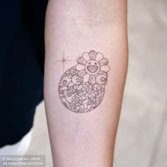 a woman's arm with a flower tattoo on it