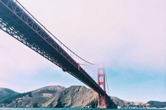 the golden gate bridge is over looking the water