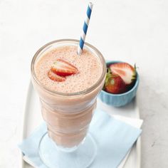 a smoothie with strawberries in it on a plate