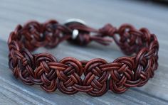 a close up of a bracelet on a wooden surface