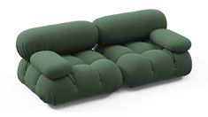 a green couch sitting on top of a white floor