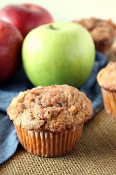 two muffins with apples in the background