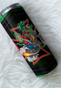 a black and green tumbler with an image of a person riding a motorcycle on it