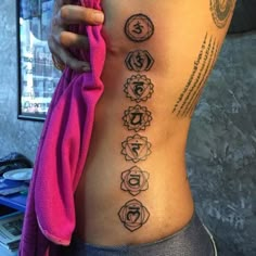 a woman's back with seven chakras on it