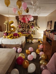 balloons and streamers fill the floor in this bedroom decorated for a 50th birthday party