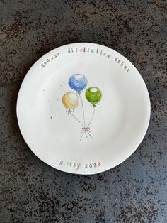 a plate with balloons painted on it