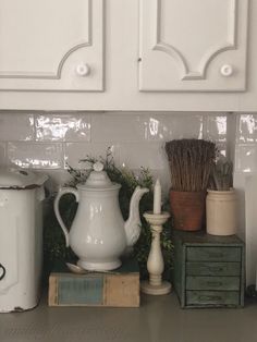 the kitchen counter is covered with various items such as teapots, candles and other things