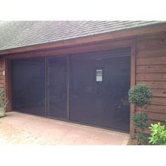 an outside view of a garage with glass doors