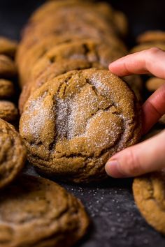 a close up of a person touching a cookie