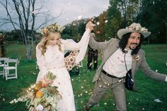 a man and woman are throwing confetti at each other