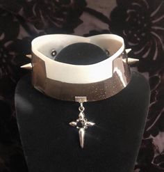 A vinyl studded collar made to resemble a clerical collar. Each side has three silver cone spikes and there is a dangling punk cross charm at the center.  Each piece of jewelry in my shop is unique, so if you see something you like, act fast! Clerical Collar, Studded Collar, Cross Charms, Choker Necklaces, Choker, Choker Necklace, Jewelry Necklaces, Vinyl, Boutique