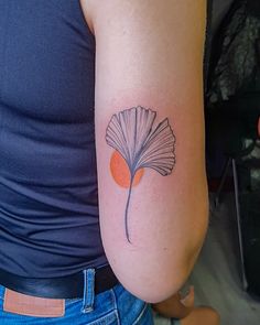 a woman's arm with a tattoo on it that has a flower in the middle