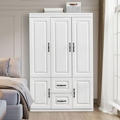 a bedroom with a bed and white cupboards