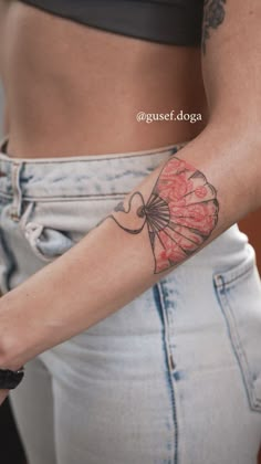 a woman with a tattoo on her arm