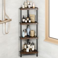 three tiered shelf in the corner of a bathroom with soaps, lotions and other personal care items