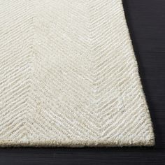 a white rug on top of a wooden floor