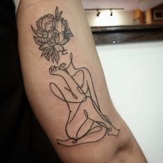 a person with a flower tattoo on their arm