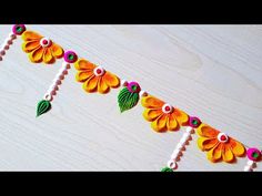 an orange and green garland with flowers on it