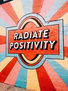 the word radiate positivity is painted on a wall with sunbursts