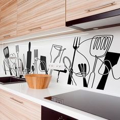 a kitchen with black and white wall decals on the backsplash