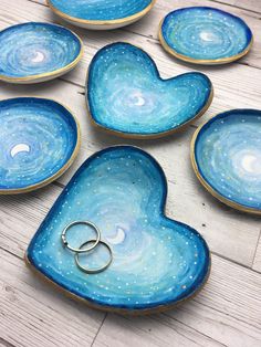 blue heart shaped dishes with rings on them