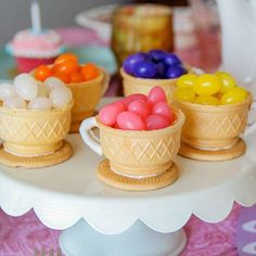 small cups filled with candy sitting on top of a table