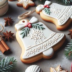 christmas cookies decorated with icing, cinnamon sticks and star anisette decorations on a table